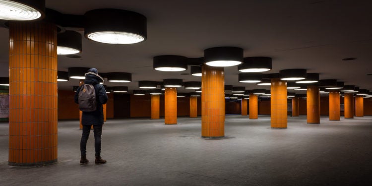 Photo of man in empty underground parking