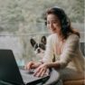 Photo of woman and dog looking at laptop
