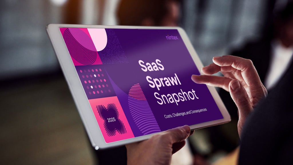 A person using a tablet looking at Nintex's SaaS Sprawl Snapshot for 2025.